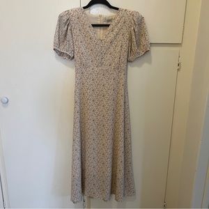 cream colored floral maxi dress with puff sleeves and shoulder pads